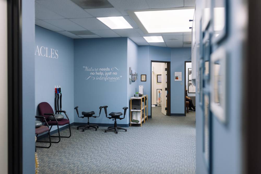 Mission Valley, San Diego chiropractic office hallway and treatment rooms Treatment room hallway with rehabilitation equipment and a wall quote about nature needing no interference